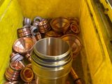 a yellow container filled with lots of copper coins