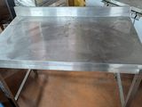 a stainless steel table that is in the middle of a room
