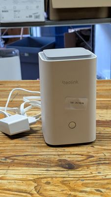 an image of a small white device sitting on top of a wooden table