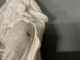 a statue of a woman holding a baby in her arms