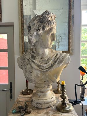 a bust of a woman sitting on a table in a room