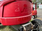 a red tractor that is parked in the grass