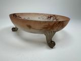 a bowl that is sitting on a stand on a white surface