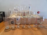 bottles and glasses are lined up on a table in front of a wooden crate