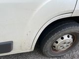 a white truck with a flat tire parked in a parking lot