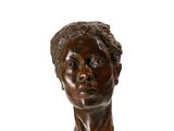 an image of a bronze bust of a woman on a white background