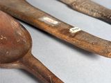 three wooden spoons and two wooden spoons on a table