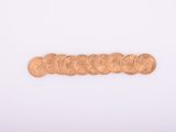 a close up of a bunch of coins on a white surface