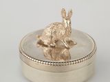 an image of a silver box with a rabbit sitting on top of it