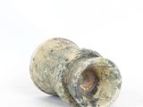 a small piece of pottery sitting on a white surface
