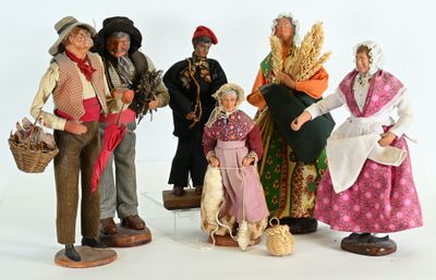 five figurines of people dressed in traditional clothing