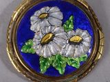 a picture of a broochee with flowers painted on it