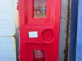 a red fire hydrant that is on the side of a building