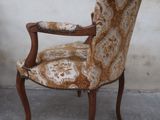 a brown and white chair that is sitting in front of a wall