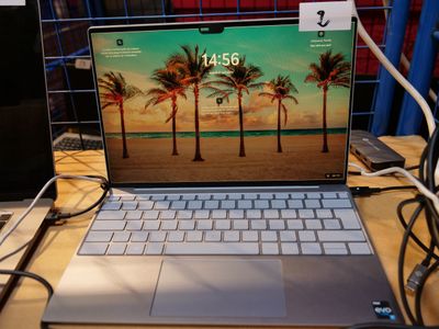 a laptop that is sitting on a table with wires