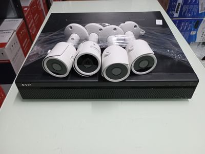 four cameras sitting on top of a box on a table