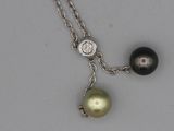 an image of a necklace with two pearls and a diamond