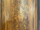 a wooden cabinet that has a floral design on it