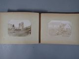 an old photo of a book opened to show a picture of a town