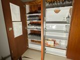 an open refrigerator in the corner of a room