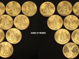 a close up of a bunch of gold coins on a black surface