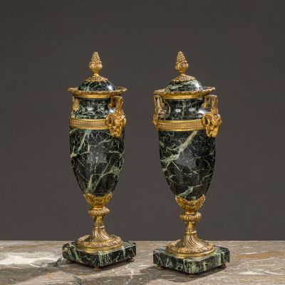 a pair of green marble urns with gold accents