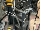 a machine that is sitting on the ground next to a pile of junk
