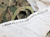 a white bag with a label on it sitting on a bed