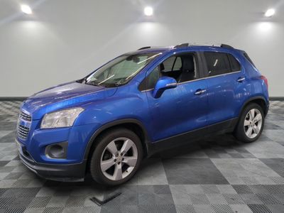 a blue chevrolet trax is parked in a large room