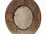 an old wooden plate with a hole in the middle