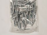 a bag of screws on a table with a white background