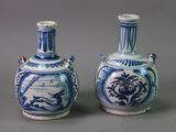 two blue and white vases sitting next to each other