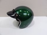 a green and black helmet on a white table