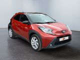 the red toyota c - hr is parked in a large room