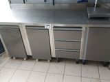 a kitchen with stainless steel cabinets and a white tile floor
