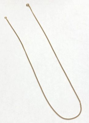 a necklace with a gold chain on a white background