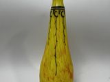 un vase jaune avec une inscription noire sur fond blanc