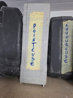 several pieces of luggage are lined up on a shelf in a room