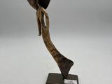 bronze sculpture of a man with a hat on his head