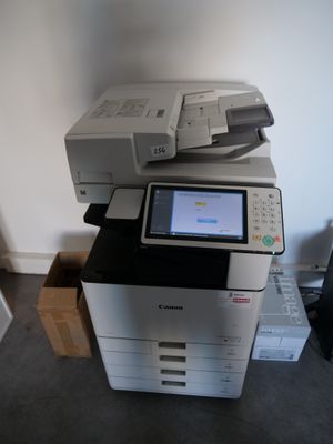 a printer that is sitting on top of a pile of boxes