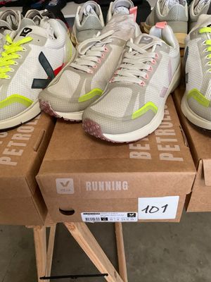 several pairs of running shoes are on a table in a store