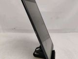 a tablet computer sitting on top of a stand on a white surface