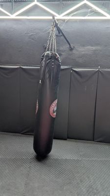 a boxing bag hanging on a wall in a gym
