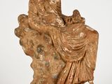 an image of a statue of a woman and child on a rock