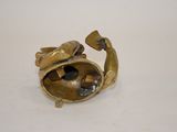 brass figurine of a fish with a shell inside of it