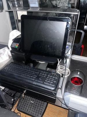 a computer sitting on a desk in the back of a bus