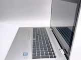 a silver laptop with a blue sticker on the screen
