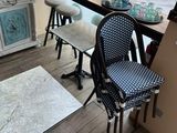 tables and chairs in front of a window in a store