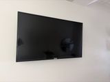 a flat screen tv mounted on a wall in a room
