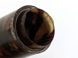 a hand holding a bottle of wine that has a cork in it